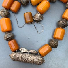 Vintage Bedouin / Yemeni pendant /amulet / hirz necklace with large Butterscotch Amber beads with hollow silver plated ribbed beads in between . Unsigned /unmarked ...Bakelite tested for simichrome and are beautifully aged with variation/ darkening of color on the edges which would only come with age and exposure to heat and light. Materials : Bakelite silver plated or very lower grade silver metal Measures : Total necklace is 37 inches in length x 7/8 inches max width ( Somebody has added the b Bakelite Necklace, Antique Signs, Amber Beads, Message Jewelry, Victorian Jewelry, Silver Filigree, Silver Enamel, Beautiful Earrings, Handcrafted Jewelry