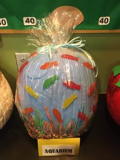 there is a plastic pumpkin with fish on it