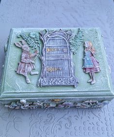 a green box with some little figurines on it