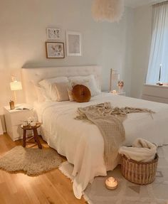 a bedroom with a white bed and wooden floors