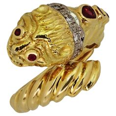 This iconic Ilias Lalaounis ring features a classic chimera design crafted in 18k yellow & white gold and set with a rose-cut diamond collar and faceted red ruby eyes. Made in Greece circa 1980s. Measurements: 0.66" (17mm) width. The ring size is 6.25 - EU 53. Resizable. Sizing fees will be provided upon request. Luxury Formal Intaglio Ruby Ring, Ilias Lalaounis Jewelry, Antique Yellow Collectible Ring, Ancient Yellow Gold Intaglio Ring, Luxury Yellow Sapphire Ring, Fine Jewelry, Ruby Diamond, 18k Yellow Gold Ring, Rose Cut Diamond, Cluster Ring