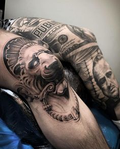 a man with tattoos on his arm laying down