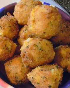 a bowl filled with fried food next to broccoli