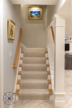 a staircase with beige carpet and white railing