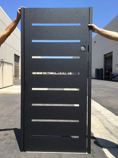 two hands are holding the door to an industrial building