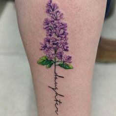 a woman's leg with a purple flower tattoo on her left calf and the word hope written in cursive writing