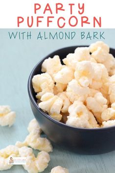 party popcorn with almond bark in a black bowl on a blue wooden table and text overlay reads party popcorn with almond bark