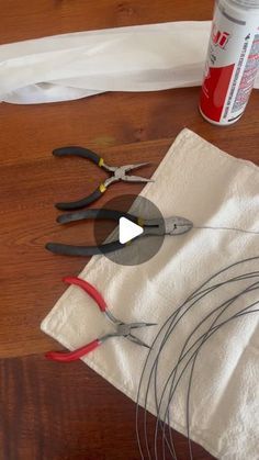 some scissors are laying on a piece of cloth next to other crafting supplies and glue