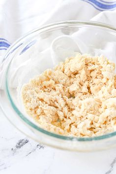 a glass bowl filled with oatmeal on top of a white and blue towel