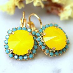 Buttercup Earrings,Swarovski Yellow Earrings,Neon Yellow Swarovski Earnings,Bridal Drop Buttercup Earrings,Bridesmaids Earrings  Dazzling Lever Back Crystal earrings feature a round rivoli cut crystal surrounded by petite Turquoise crystals set on a secure prong settings. The perfect shade for cocktail parties or to add a touch of color to your wedding ensemblePetite Delights is an Official SWAROVSKI® Branding Partner Our brand is legally licensed & authorized By Swarovski Company for high quali Yellow Earrings With Ear Wire For Wedding, Yellow Ear Wire Earrings For Wedding, Yellow Wedding Earrings With Ear Wire, Turquoise Crystals, Bridesmaids Earrings, Blue Crystal Earrings, Yellow Jewelry, Swarovski Crystal Jewelry, Turquoise Crystal