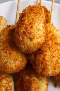 several fried food items on a plate with toothpicks sticking out of the top