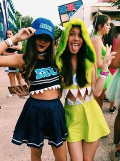 two girls dressed in costumes posing for the camera