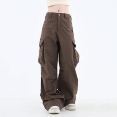 These classic-style brown pants feature a wide fit with cargo pockets Size: • S: Waist: 62cm/ 24.4 in, Length: 100cm/ 39.4 in• M: Waist: 66cm/ 26.0 in, Length: 101cm/ 39.8 in• L: Waist: 70cm/ 27.6 in, Length: 102cm/ 40.2 in• XL: Waist: 74cm/ 29.1 in, Length: 103cm/ 40.6 in• XXL: Waist: 80cm/ 31.5 in, Length: 104cm/ 40.9 inMaterial: Cotton, Polyester Brown Parachute Pants For Fall, Brown Fall Bottoms For Streetwear, High-waist Brown Parachute Pants For Fall, High Waist Brown Parachute Pants For Fall, Brown Bottoms With Side Pockets For Fall, Brown Straight Leg Cargo Jeans With Hip Pockets, Brown Full Length Cargo Pants, Full Length Brown Cargo Bottoms, Brown Full Length Cargo Bottoms