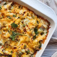 a casserole dish with broccoli, cheese and other toppings on it