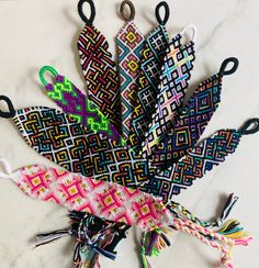 several pairs of scissors are sitting on a table with different colors and patterns in them