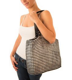 a woman holding a black and white bag