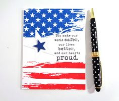 an american flag with a pen on it and a notepad that says, you make our world safer, our lives better, and our hearts proud