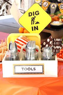 an orange table topped with lots of different types of utensils and other items