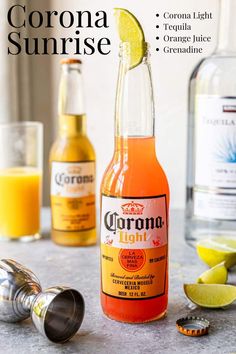 a bottle of corona sunrise sitting on top of a counter next to some lemon wedges