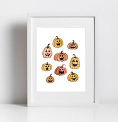 a white frame with pumpkins and jack - o'- lantern faces on it