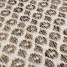 a close up view of the texture of a rug with animal prints on it,