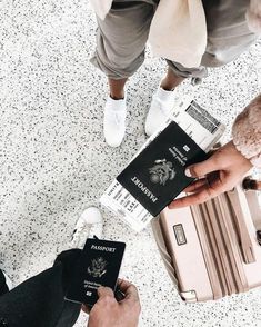 people holding their luggage and passport at the airport