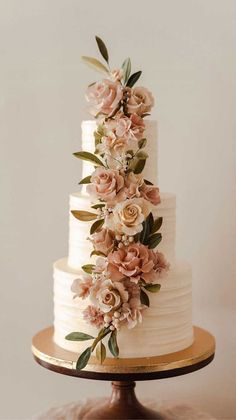 a white wedding cake with flowers on top