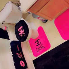 pink and black bathroom rugs with the word chanel painted on them