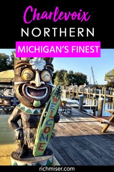 a wooden statue with the words charlotte's northern michigan finest on it in front of a dock