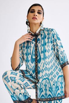 Aqua silk cropped shirt tunic with abstract print.
Components: 1
Pattern: Printed
Type Of Work: Abstract
Neckline: Collar
Sleeve Type: Half
Fabric: Silk
Color: Blue
Other Details: 
Closure : Front buttons
Note : Pant, jewellery and footwear worn by the model are not for sale.
Occasion: Mehendi and Haldi - Aza Fashions Festive Silk Tops With Printed Motifs, Festive Silk Printed Blouse, Bohemian Blouse With Printed Motifs For Eid, Festive Printed Tunic Blouse, Bohemian Tops With Ikat Print For Festive Occasions, Bohemian Ikat Print Tops For Festive Occasions, Summer Blouse With Printed Motifs In Straight Kurta Style, Summer Kurta Blouse With Printed Motifs, Elegant Silk Blouse With Digital Print