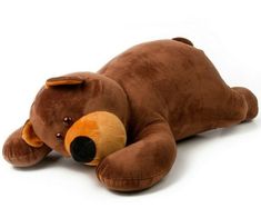 a brown teddy bear laying on its side