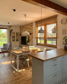 an open kitchen and dining room area with sliding glass doors leading to the outside patio