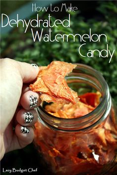 a hand holding a jar filled with dried watermelon candy and text overlay reads how to make dehydrated watermelon candy