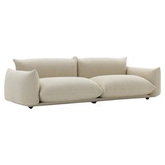 a white couch with two pillows on the back and one arm folded out to show it's shape