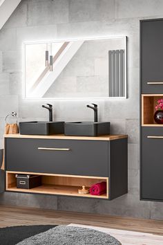 a bathroom with two sinks and a mirror on the wall next to a gray rug