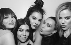 black and white photograph of four women posing for the camera