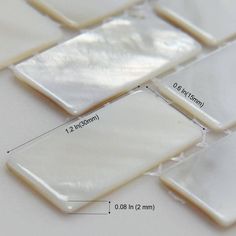 a close up view of some white glass tiles