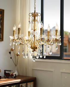 a chandelier hanging in front of a window