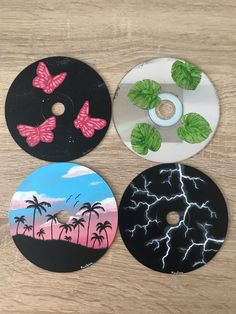 three discs with different designs on them sitting on a table