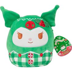 a green stuffed animal with red eyes and ears