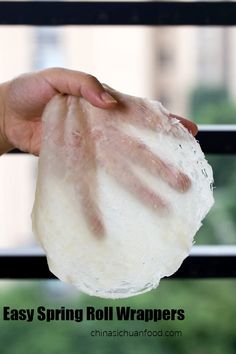 a hand holding a ball of toilet paper in front of a window with the words easy spring roll wrappers on it