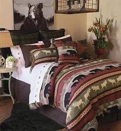 a bedroom with a bed covered in a colorful blanket and pillows, next to a painting on the wall