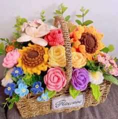 a basket filled with lots of colorful flowers