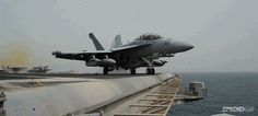 a fighter jet sitting on top of an aircraft carrier