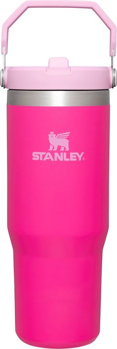 the stanley insulated tumbler is pink and has a handle on one side that holds an insulated cup