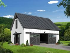 a white barn with a black roof and two garage doors on the side of it