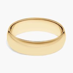 a yellow gold wedding ring on a white background