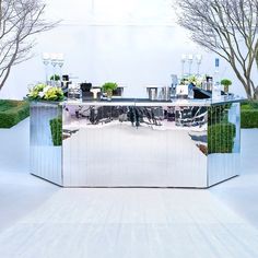 an outdoor bar with plants and flowers on it