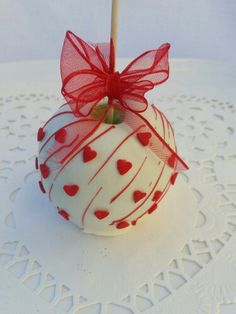 a white cake pops with red hearts on it