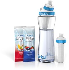 a blender and two bags of liquid next to each other on a white surface